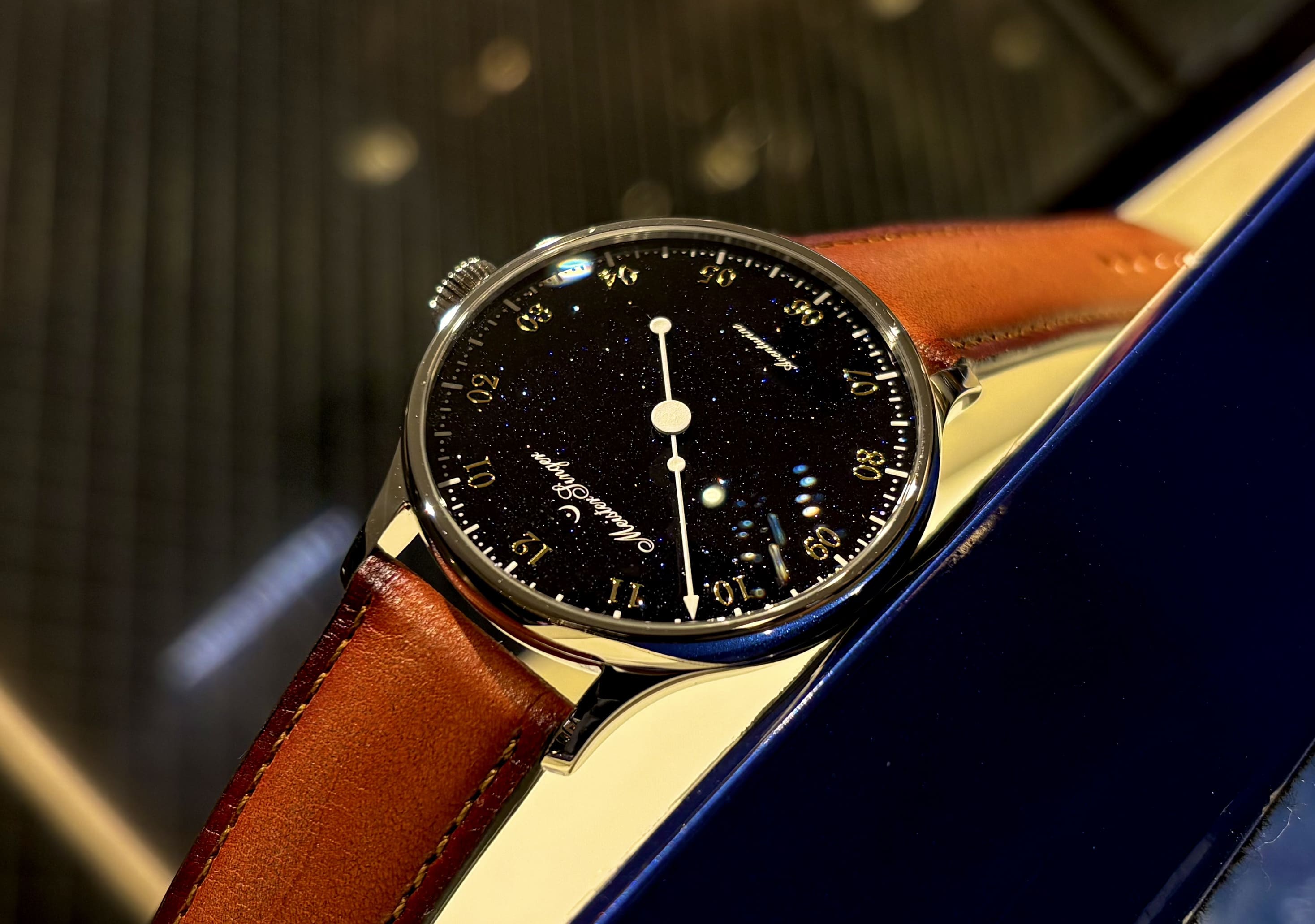 マイスタージンガー（MeisterSinger） パンゲア アベンチュリン 深いブルーダイヤルに無数の微光が瞬く、一本針の機械式腕時計。スイス製ムーブメントSellita SW200を搭載し、静かに時を刻むその姿は、冬の夜空を切り取ったかのよう。一本針が生む余白がアベンチュリンの奥行きを際立たせる、クラフツマンシップと美の融合モデル。